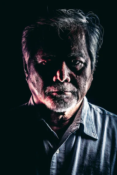 Rugged old man portrait. Old asian man with white beard. Dramatic lighting.