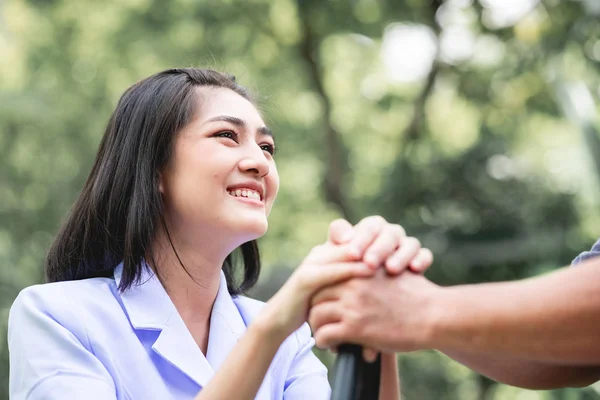 Comforting Hand Young Nurse Holding Old Man Hand Outdoor Garden — Stock Photo, Image