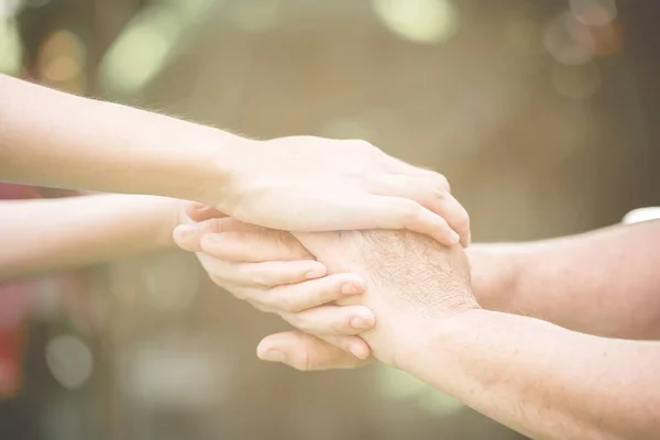 Comforting Hand Young Nurse Holding Old Man Hand Outdoor Garden — Stock Photo, Image