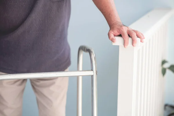 Old man at home using a walker. Asian man, senior lifestyle concept.