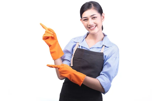 House cleaning service woman isolated in white. Asian young woman with gloves, happy smile, pointing finger. House cleaning service concept.