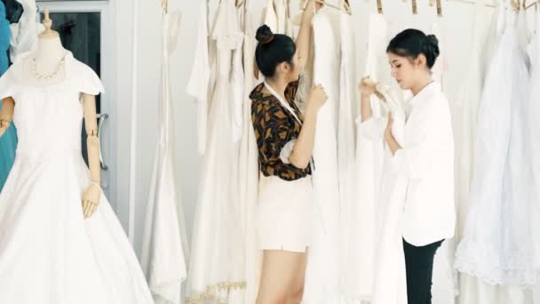 Молодой Дизайнер Свадебных Платьев Работает Молодая Азиатка Пытается Продать Покупателю — стоковое видео