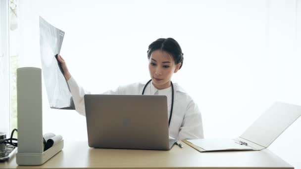 Jovem Mulher Asiática Médico Sentado Sua Mesa Examinar Perfil Médico — Vídeo de Stock