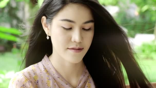 超级慢动作的年轻美丽的亚洲女人肖像在她的家庭花园与绿色树的背景 特写镜头 千禧年生活方式概念 — 图库视频影像