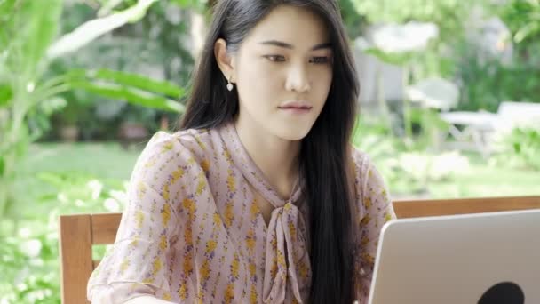 Wanita Muda Asia Menarik Yang Bekerja Pada Laptop Kebun Rumahnya — Stok Video