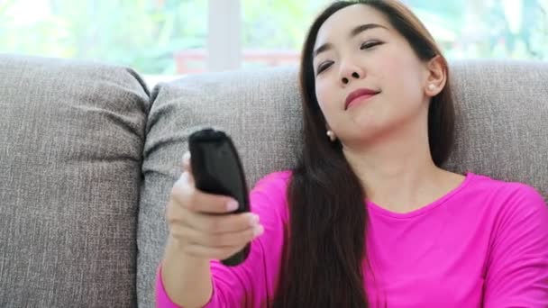 Young Attractive Asian Woman Laying Couch Home Using Television Remote — Stock Video