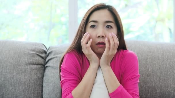Young Attractive Asian Woman Sitting Couch Home Watching Horror Movie — Stock Video