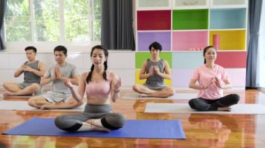 Yoga sınıfına katılan genç ve üst düzey Asyalı bir grup, meditasyon. Grup spor yaşam tarzı.