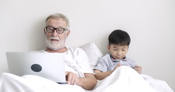 Young Asian Boy Using Mobile Phone His Grandfather Using Laptop — Stock Video