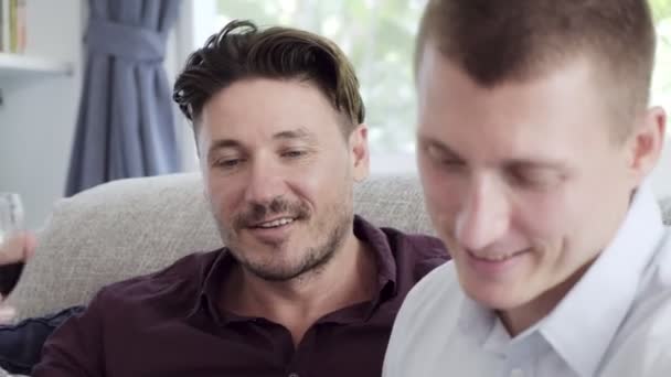 Caucasian Gay Couple Reading Book Drinking Wine Home — Stock Video