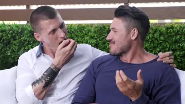 Caucasian Gay Couple Sitting Garden Eating Apple — Stock Video