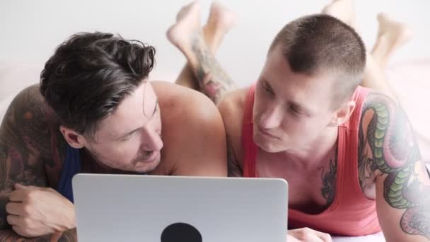 Kaukasiska Homosexuella Par Ligger Sängen Och Titta Något Laptop Hemma — Stockvideo