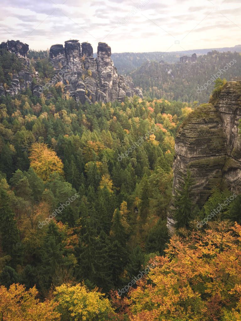 Great morning mood with fog and clouds at the Bastei, a rock formation close to the Elbe River in the german Saxon Switzerland National Park. Hiking and climbing in wonderful mountain ranges of the Elbe Sandstone Mountains.