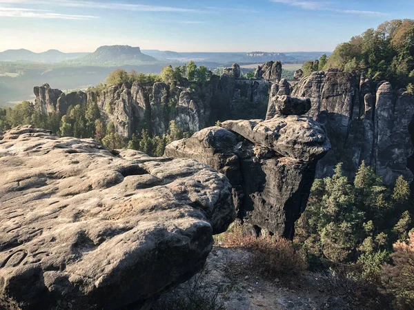 Sunrise at the Bastei bridge above the Elbe River in the Elbe Sandstone Mountains of Germany. One of the most spectacular hiking regions in Europe. The bizarre, primeval landscape of the Saxon Switzerland simply overwhelms visitors.