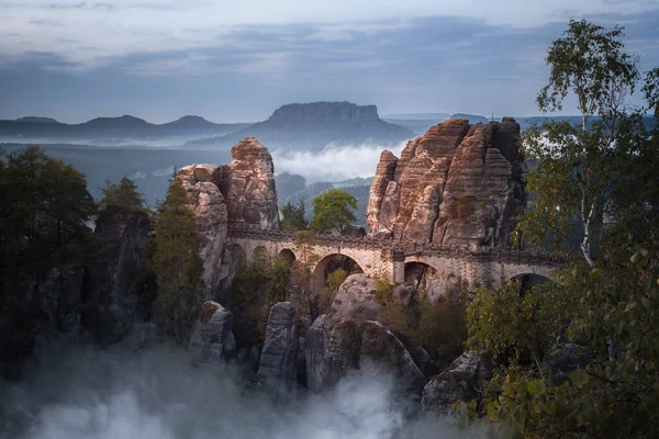 Dark mood at the Bastei bridge above the Elbe River in the Elbe Sandstone Mountains of Germany. One of the most spectacular hiking regions in Europe. The bizarre, primeval landscape of the Saxon Switzerland simply overwhelms visitors.