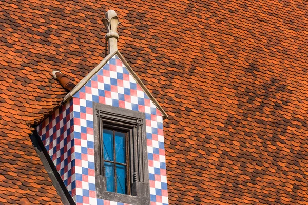 Beautiful window in the roof of the old house — Stock Photo, Image