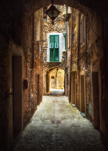Narrow pedestrian street and cozy countryard in the old town of Dolceacqua, Imperia province, Italy