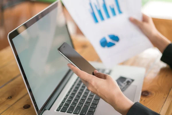 Geschäftsfrau mit Finanzdiagrammen und Laptop — Stockfoto