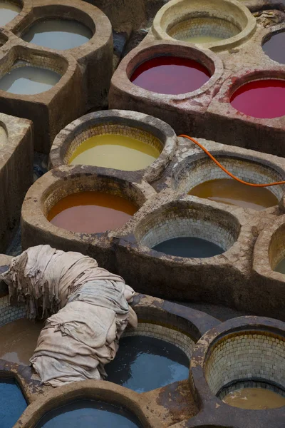 Painting the leather in Fez, the ancient tanneries in the heart of medina