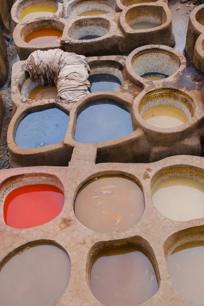 Painting the leather in Fez, the ancient tanneries in the heart of medina