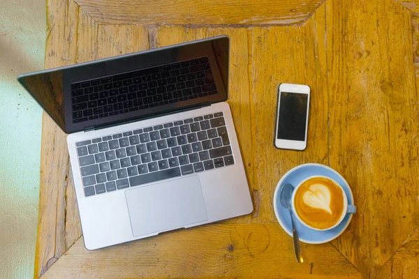 working in a cafeteria with coffee and computer