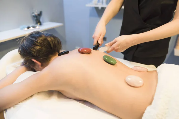 Massages with hot stones in beauty center