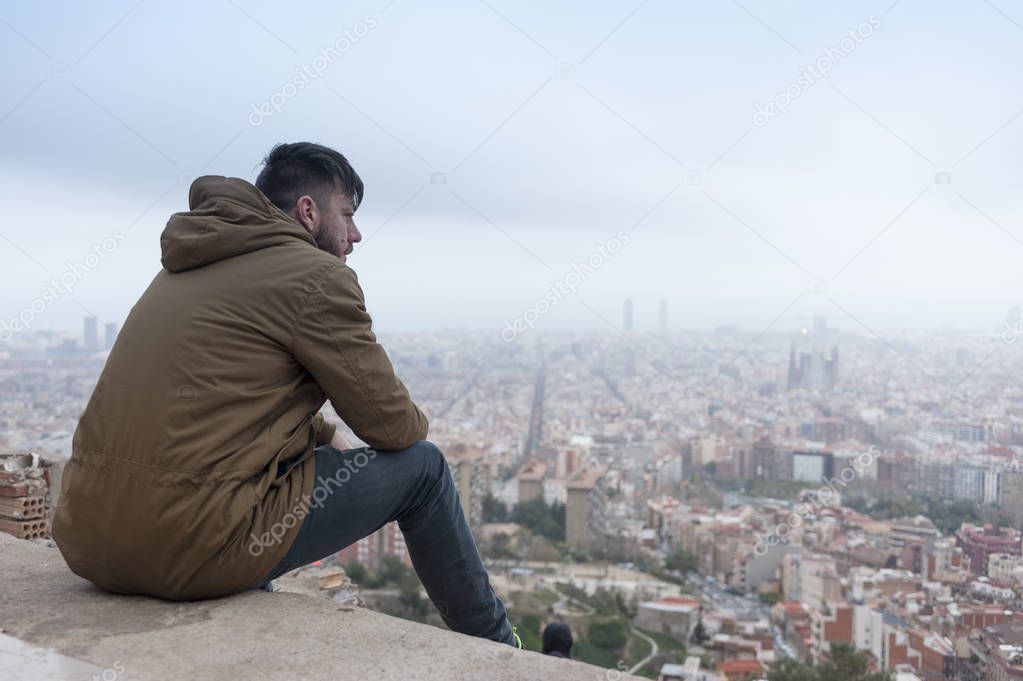 hipster man enjoys the view at famous EL Carmel Bunkers in Barcelona