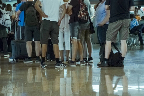 Low section of people at airport waiting for plane