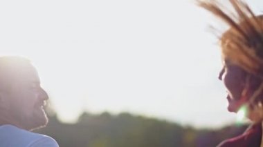 Adam ve kız mutlu bir şekilde açık havada vakit geçirirler. Aşk atlama ve spin ve gün batımı parkta etrafında aptal bir çift.