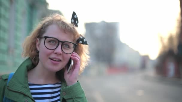 Una Chica Joven Bonita Con Gafas Está Hablando Por Teléfono — Vídeo de stock