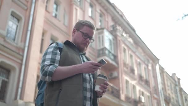 Jovem Bonitão Com Uma Caneca Café Telemóvel Rua Turista Está — Vídeo de Stock