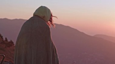 Bir grup genç arkadaş dağda gün doğumuyla karşılaşıyor. Uyku tulumlarında uyuyan turistler, uçurumun kenarındaki sandalyelerde oturuyorlar. Güneşin doğuşuyla dağın eteğindeki muhteşem şehir manzarası..