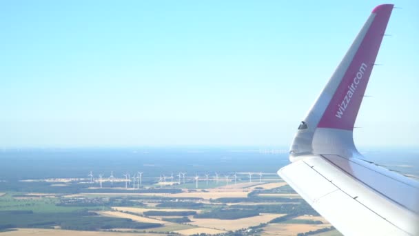 Airplane in flight over the Europe. Windmills in background. Magdeburg, Germany. 30.09.2018 — Stock Video