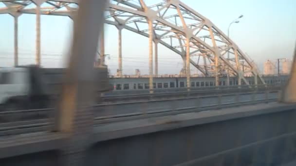 Railway lines shines by sun rays, over Dnipro river. Kyiv — Stock Video