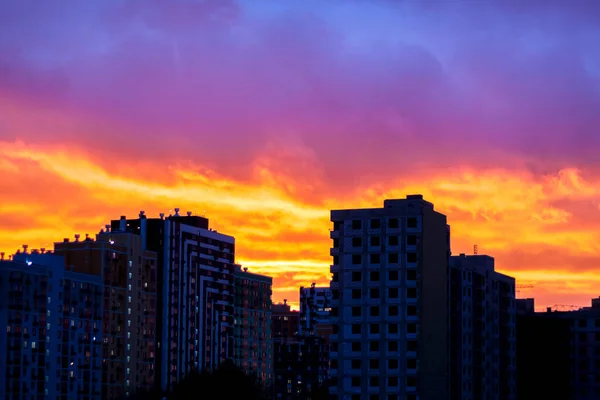 Sunset in the city. Fire, a beautiful sunset over the houses of the city. Fire sky.