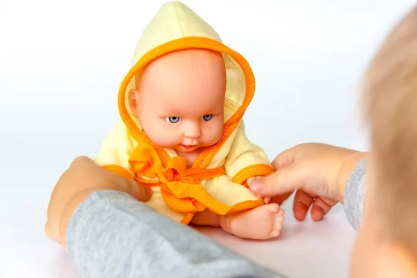 Child Plays Doll Doll White Background Close Child Hand White — Stock Photo, Image