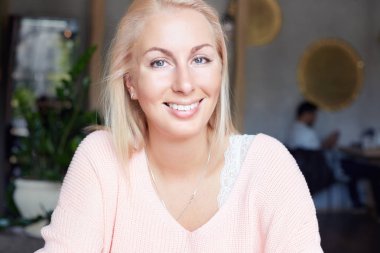 Güzel bayan mükemmel dişleri ve geri kalanı kapalı olması, mutlu bir şekilde alınan iyi olumlu haber sonrasında gülümseyen temiz cilt ile çekim kapatın. Sarışın ve mavi gözlü güzel genç kadın rahatlatıcı.