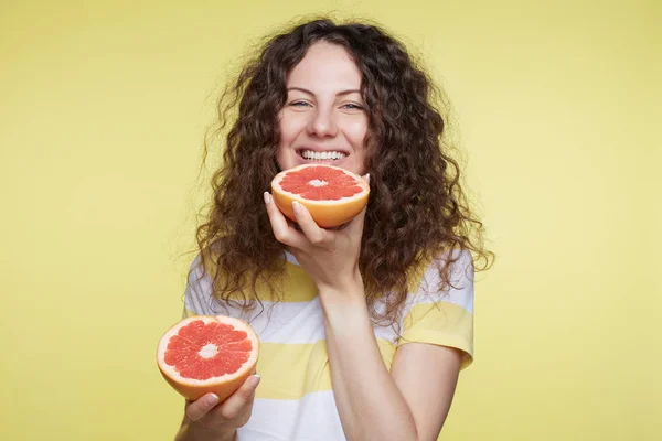 Fresh, good happy Sunday morning. Young and healthy curly haired, blue eyed beautiful model is going to have tasty and natural breakfast, demonstrating perfect teeth, smiling with pleasure at camera