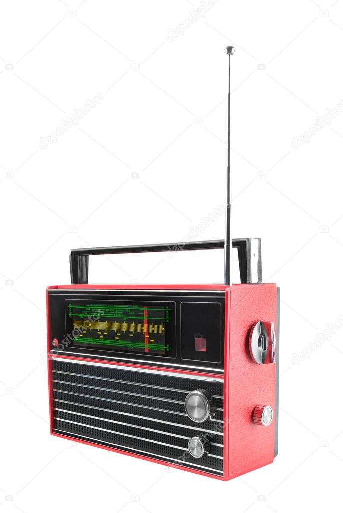 View from side of old red transistor portable radio receiver with telescopic antenna. Isolated on white background 