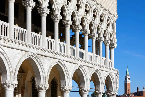 Venice, Doge palace open gallery and San Giorgio Maggiore bell tower in a sunny summer day in Italy