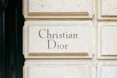 PARIS, FRANCE - JULY 21 22, 2017: Christian Dior sign carved in stone in 30 avenue Montaigne in Paris, France. clipart