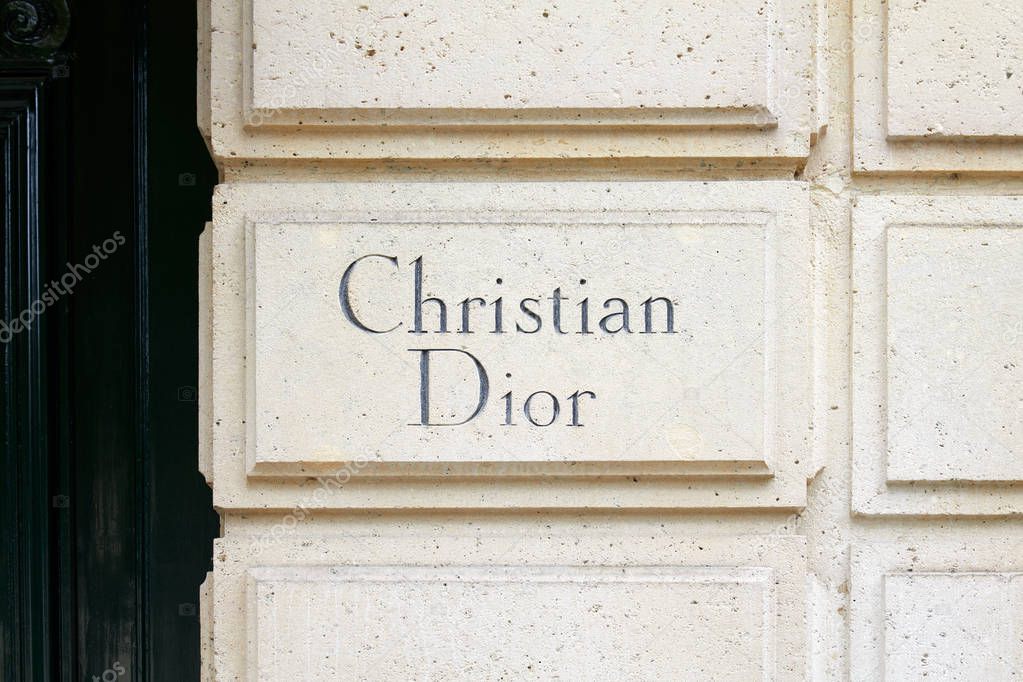PARIS, FRANCE - JULY 21 22, 2017: Christian Dior sign carved in stone in 30 avenue Montaigne in Paris, France.
