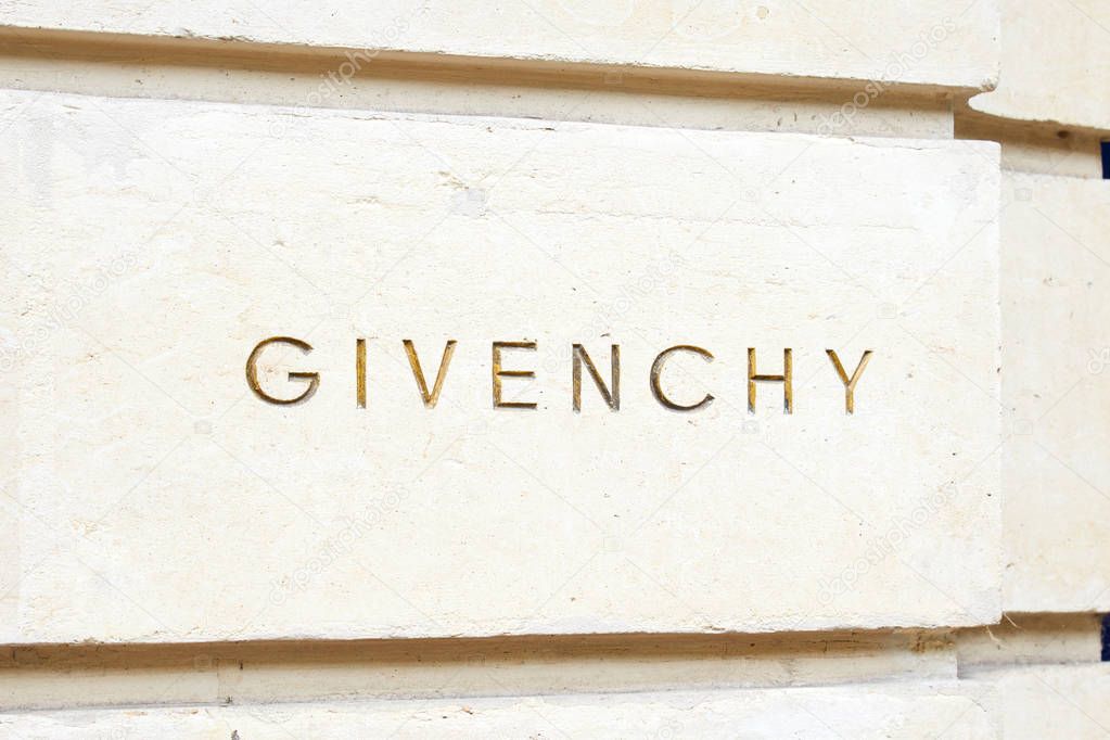 PARIS, FRANCE - JULY 22, 2017: Givenchy, luxury fashion sign carved in stone in avenue George V in Paris, France.