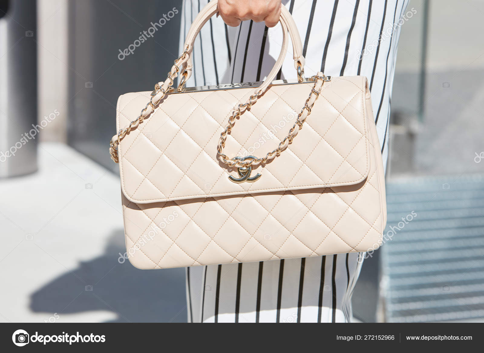 Woman with pale pink Chanel leather bag and pinstripe trousers before  Alberto Zambelli fashion show, Milan Fashion Week street style on September  20, 2017 in Milan. – Stock Editorial Photo © AndreaA. #272152966