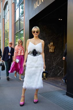 Bella Potemkina with white fur dress before Fendi fashion show, Milan Fashion Week street style on September 21, 2017 in Milan.