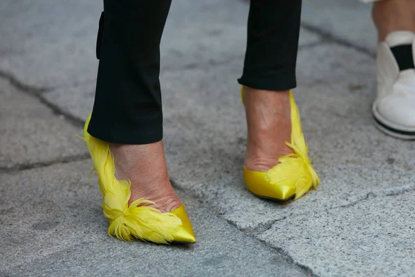 Mujer con zapatos amarillos con decoración de plumas antes del desfile de moda Max Mara, Milan Fashion Week street style el 21 de septiembre de 2017 en Milán . — Foto de Stock