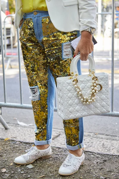 Woman with golden sequin decorated jeans and white Dior bag before Fendi fashion show, Milan Fashion Week street style on September 21, 2017 in Milan. — Stock Photo, Image