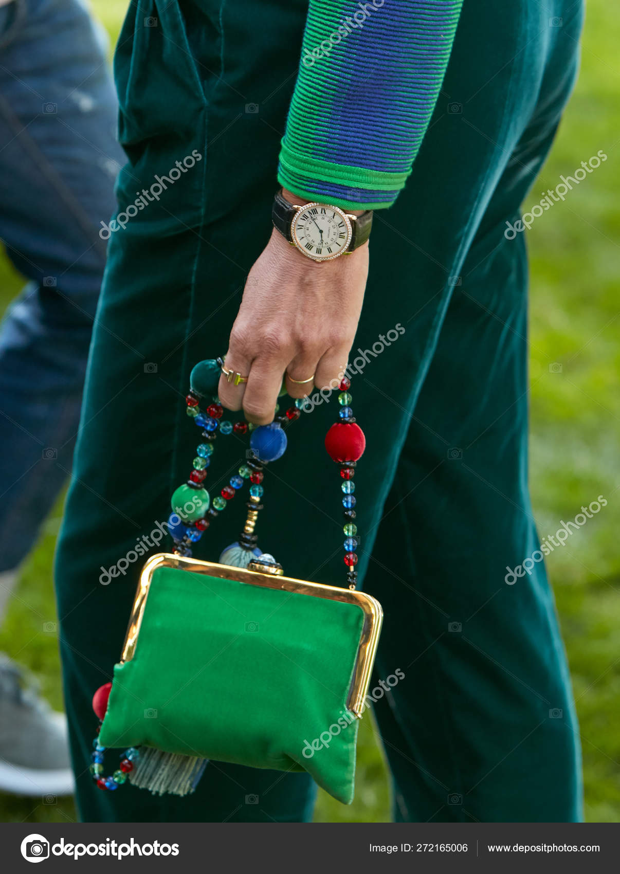 Woman with Ronde de Cartier watch and green velvet trousers and