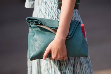 Woman with green leather bag and dress before Gabriele Colangelo fashion show, Milan Fashion Week street style on September 23, 2017 in Milan.