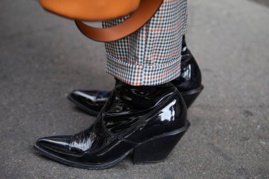 Woman with black patent leather pointed boots before Ermanno Scervino fashion show, Milan Fashion Week street style on September 23, 2017 in Milan. clipart